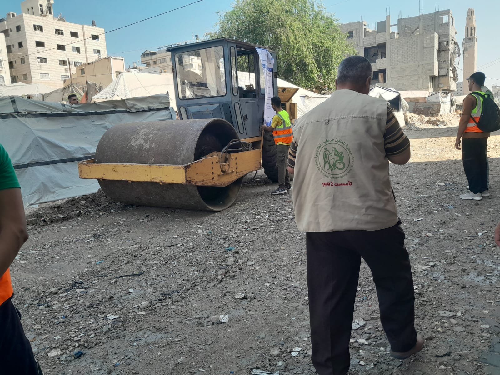 From the Ground Up: Building Al-Lababidi Clinic in Gaza Road roller and workers compacting the approach road near the clinic