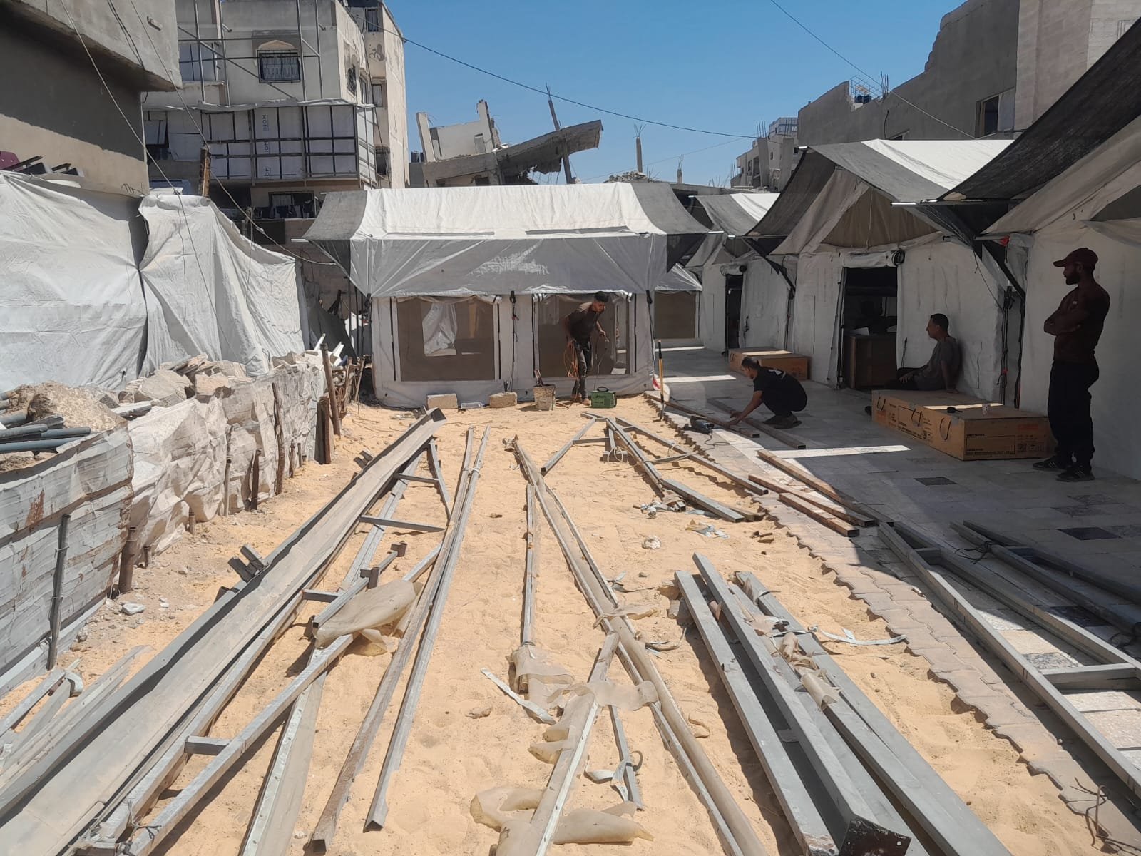 From the Ground Up: Building Al-Lababidi Clinic in Gaza Metal beams laid out in the clinic grounds during canopy construction