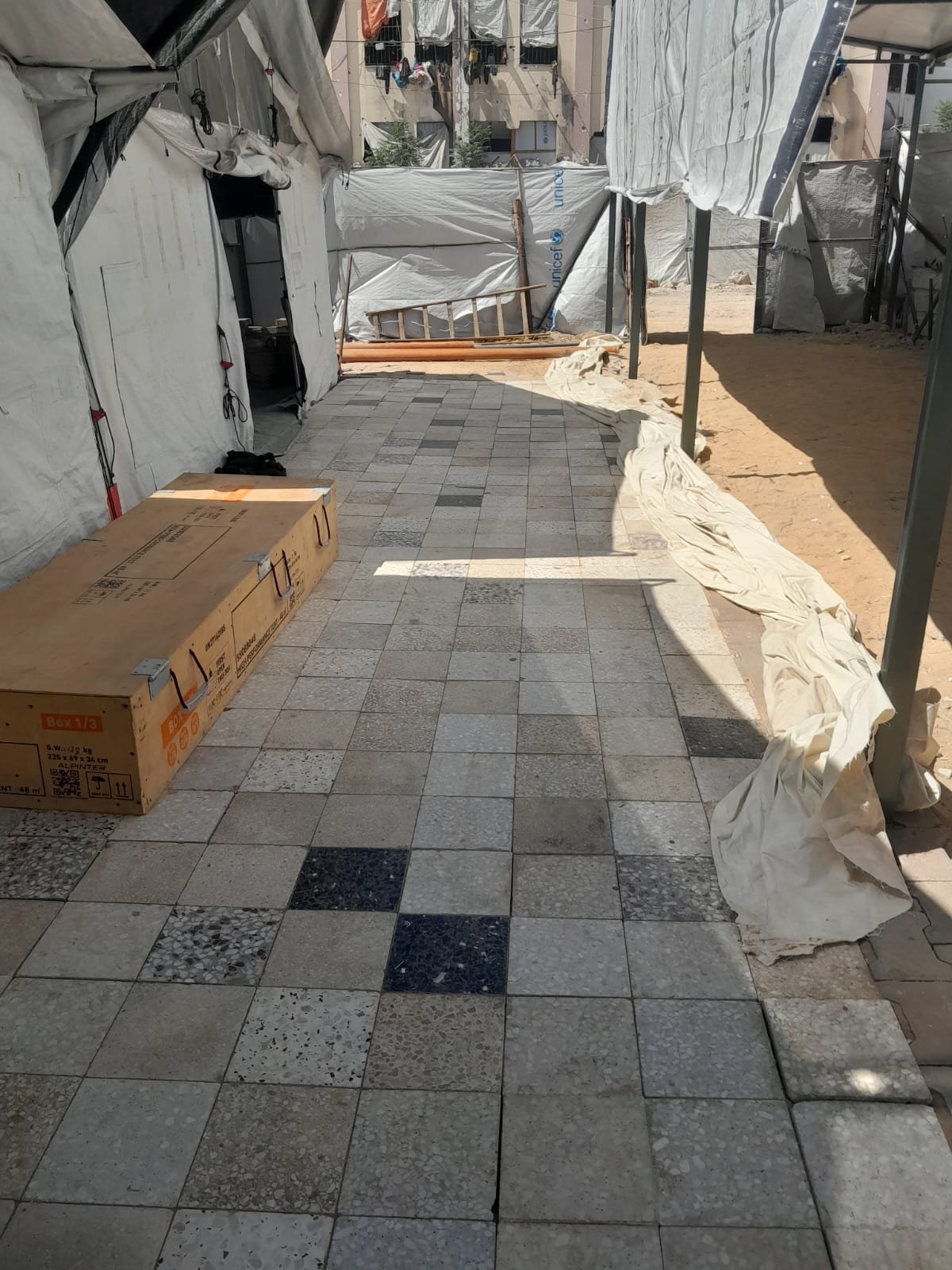 From the Ground Up: Building Al-Lababidi Clinic in Gaza Completed tiled walkway between tents at Al-Lababidi Clinic