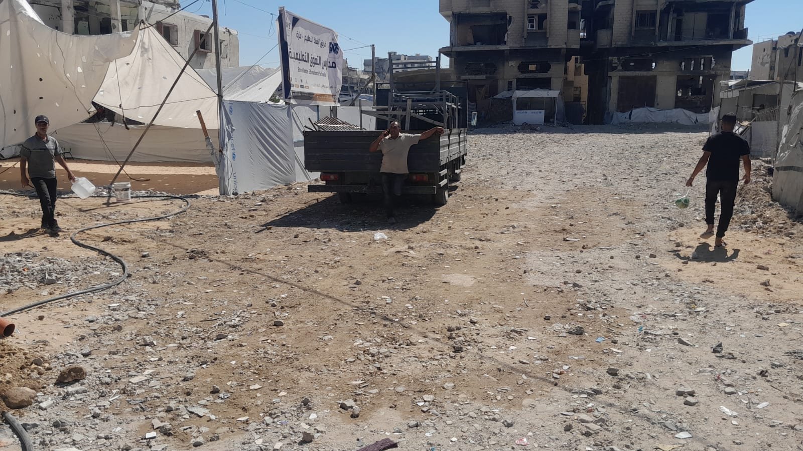From the Ground Up: Building Al-Lababidi Clinic in Gaza Prepared road surface between tents and nearby buildings